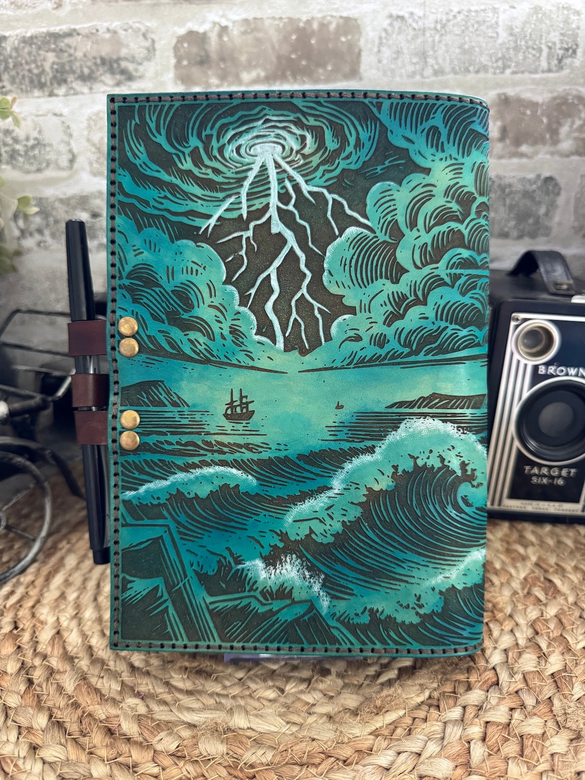 He Calmed the Storm Leather Journal – Tattooed Lighthouse & Storm Design